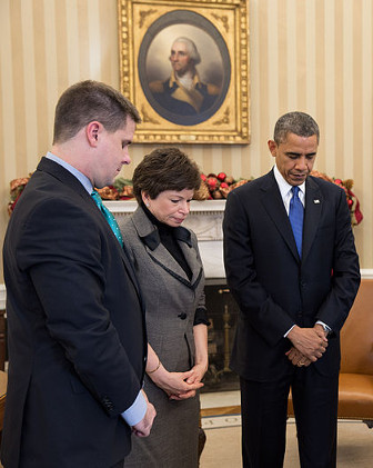 President Obama and others observing a minute of silence